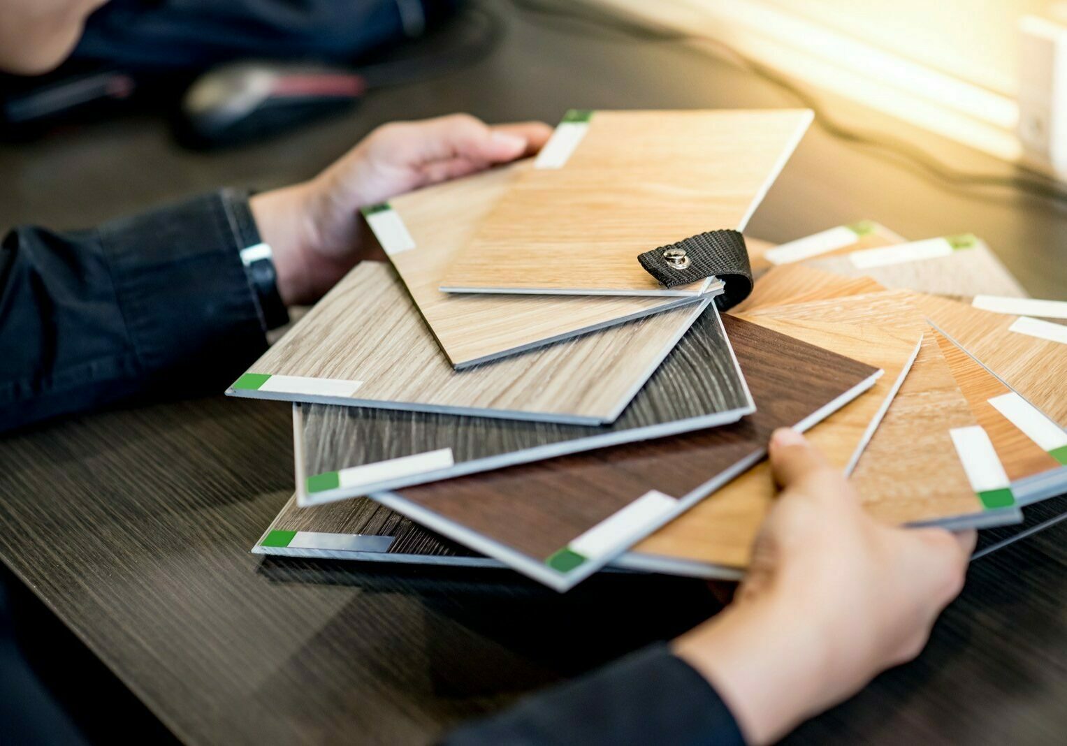 Asian architect man choosing wooden color swatch Male architect or interior designer holding wooden color swatch choosing wood material for housing project. Sample of wood laminated chipboard for furniture design. Architecture and construction.