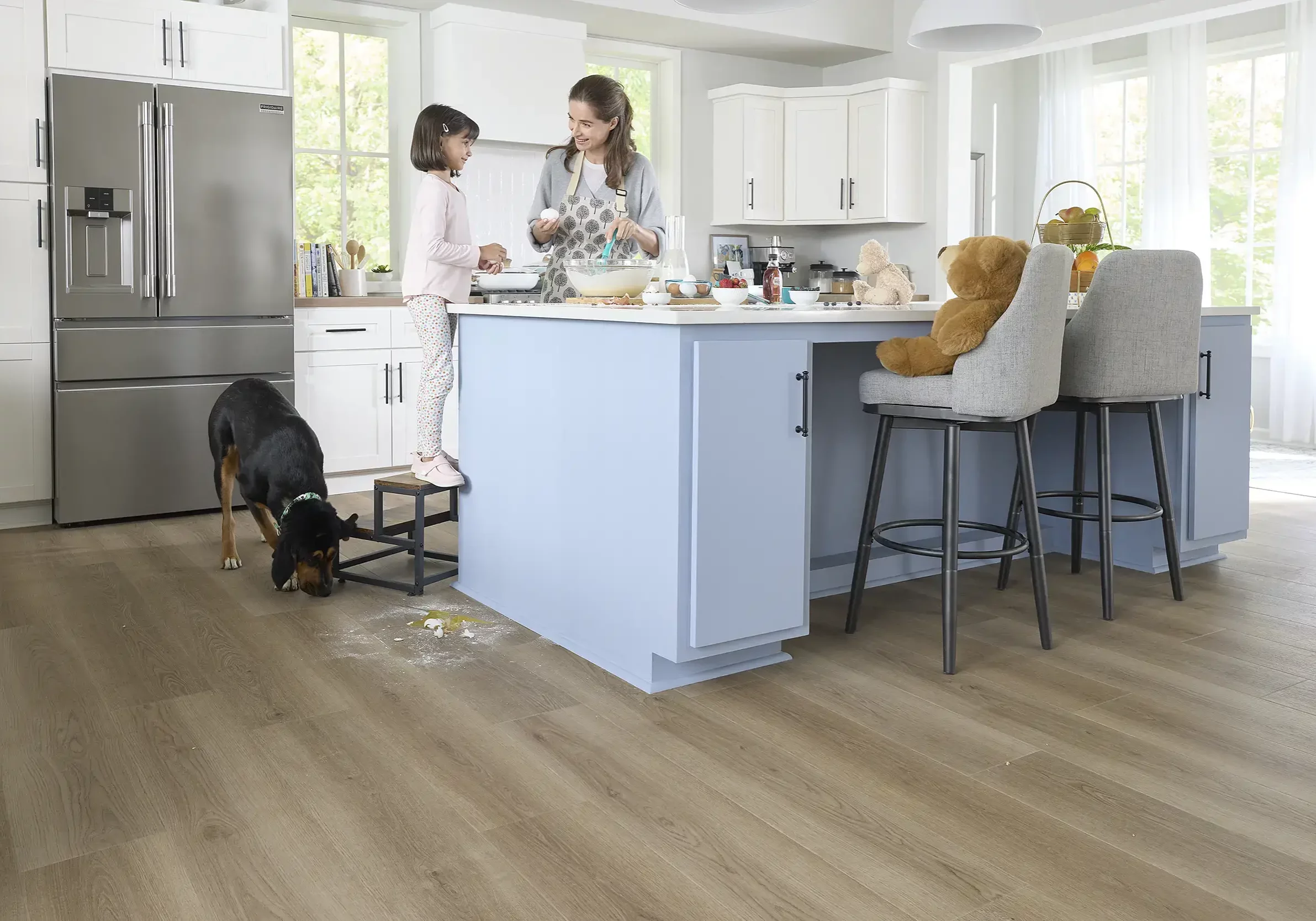 Lady with baby and dog in kitchen