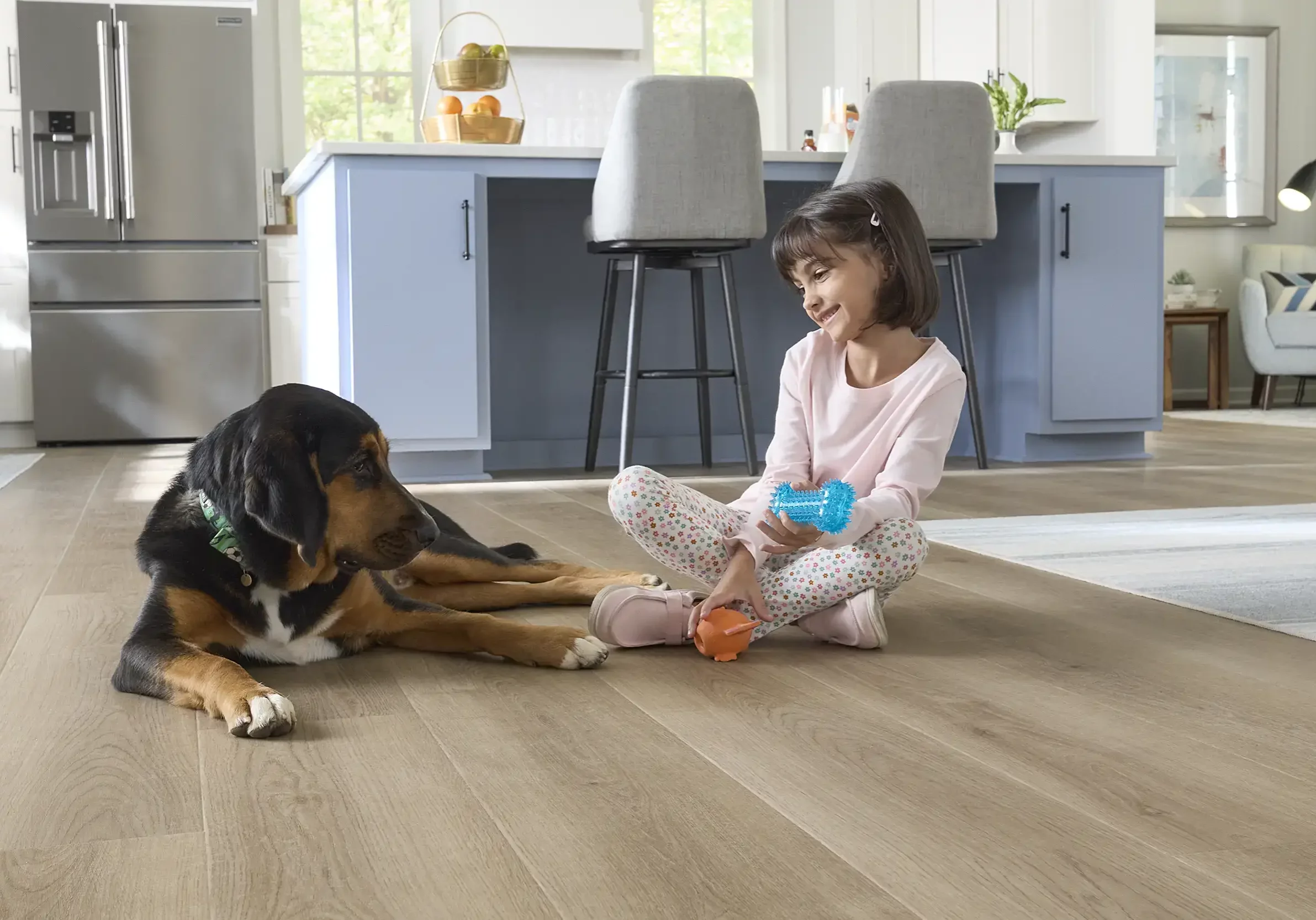 Baby girl playing with dog